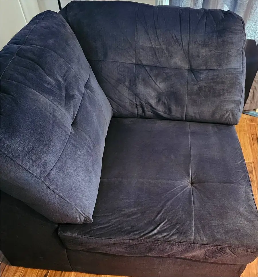 A navy sectional corner seat after upholstery cleaning