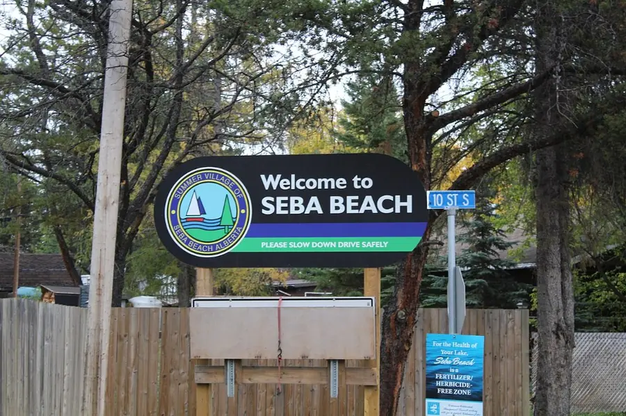 The Welcome to Seba Beach sign among the trees