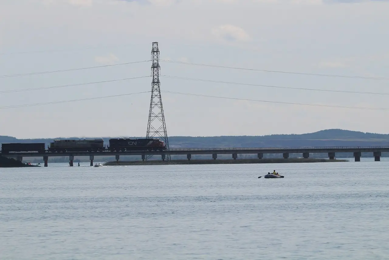 A freight train crossing the rail bridge over Wabamun Lake