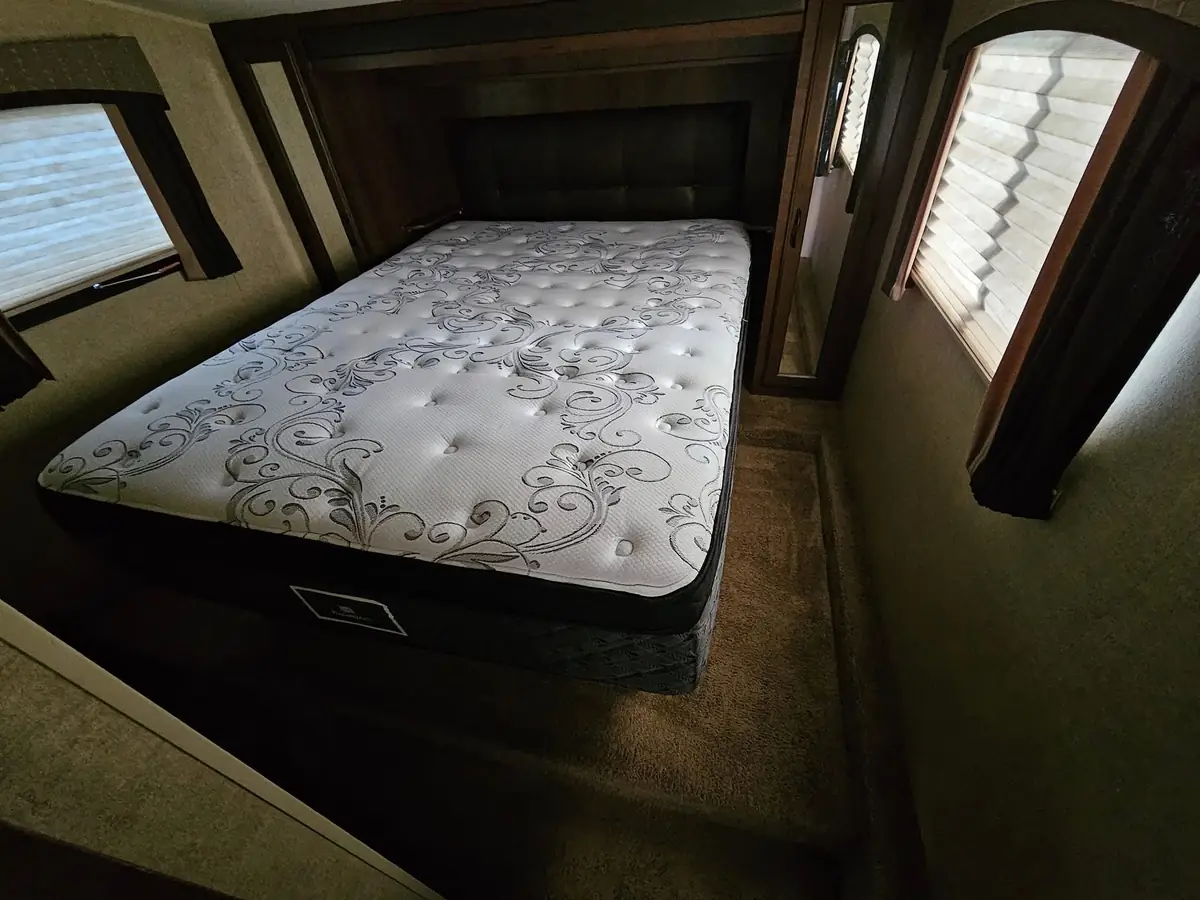 A clean mattress in the bedroom of a holiday trailer
